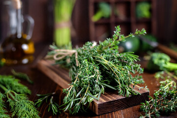 bunch of herbs, greens, rosemary, thyme tied with rope in the kitchen, selective focus. vegetarian, healthy, raw food