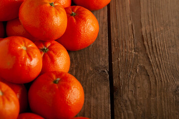 Fresh tangerines on a wooden table with copy space.
