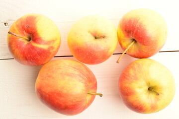 Several ripe organic, juicy, aromatic apples, close-up, on a wooden table.