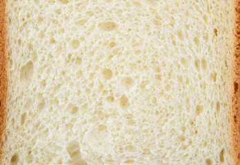 Close-up of a piece of white wheat bread with brown crusts around the edges