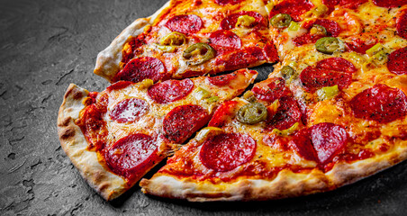 Pepperoni Pizza with Mozzarella cheese, salami, Tomato sauce, pepper, Spices. Italian pizza on Dark...