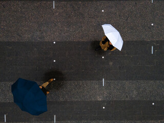 man and woman with umbrella view from above