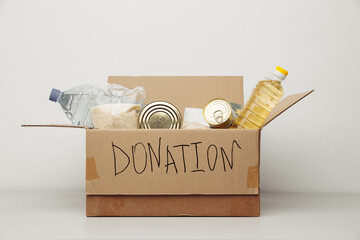 Donation and Charity concept. Open cardboard box with various food.