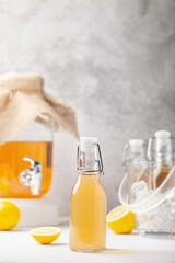 Refreshing filtered kombucha tea in a glass bottle and a jar. Healthy drink