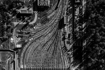 Public transport theme. aerial creative top view to metro depot heavy rail, subway, tube, metropolitana or underground. Black and white square design composition. Abstract representation of industry 