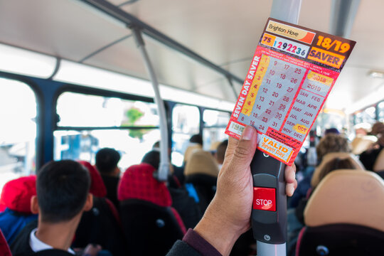 Brighton, England-1 October,2018: Student or tourism holding the Brighton & Hove seven day saver bus pass ticket at bus bell switch inside the public bus route.
