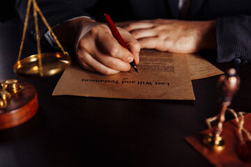 Notary's public pen and stamp on testament and last will. Person in office signing documents.