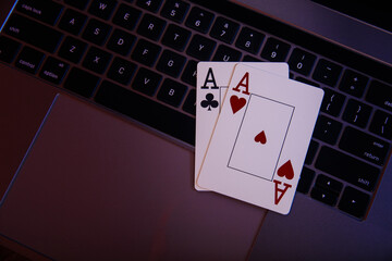Online gambling theme. Aces on a laptop's keyboard. Top view.