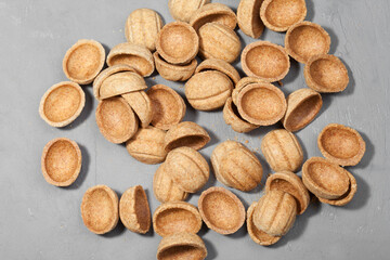 Homemade cookies nuts with condensed milk on a wooden table. Empty halves for filling