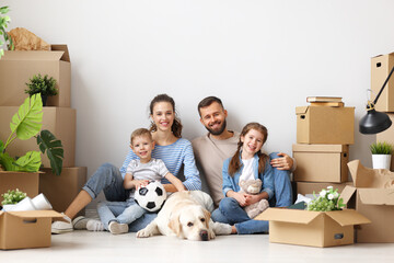 Cheerful family sitting of floor in new apartment