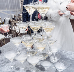 Pyramid of glasses with champagne close up.