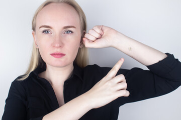 The woman shows his hand with a chip implanted. The concept of chipping and implantation of electronic technologies into the human body. Cybernetics and the nanofuture. Cyberpunk