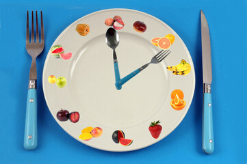 Concept de régime fruits avec une horloge faite avec une assiette et des couverts