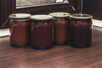 Various marmalade in glass jars in the kitchen