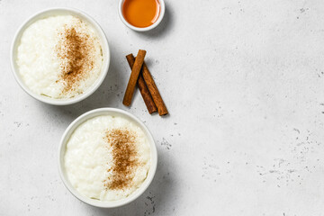 Creamy rice pudding in bowls. Top view, space for text.