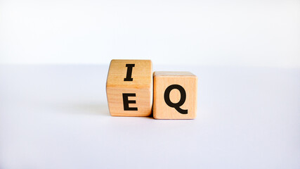 IQ or EQ symbol. Turned a cube, changed words IQ, intelligence quotient to EQ, emotional quotient. Beautiful white background. Concept of emotional and intelligence quotient. Copy space.