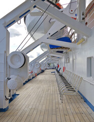 Sun loungers or deck chairs on outdoor boat or promenade deck of classic cruiseship or cruise ship...