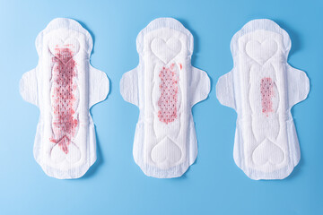 Set of different used sanitary pad, Sanitary napkin on blue background. Menstruation, Feminine hygiene, top view.
