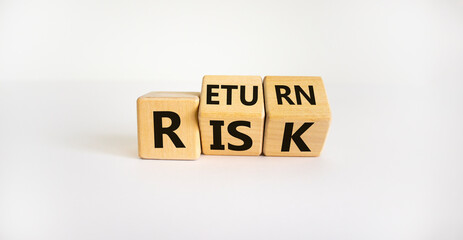 Risk or return symbol. Turned wooden cubes and changed the word 'risk' to 'return'. Beautiful white background. Risk or return and business concept. Copy space.