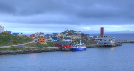Fototapeta premium A view of the entrance to the harbour of Honningsvag, Norway under the midnight
