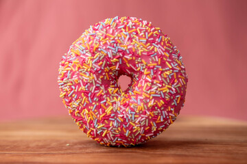 Pink donut on a pink background