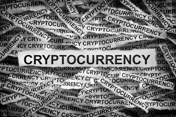 Torn pieces of paper with the word Cryptocurrency
