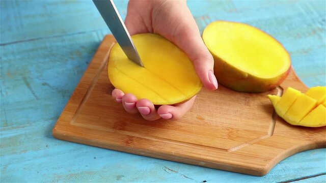 woman hands cutting mango fruit close up