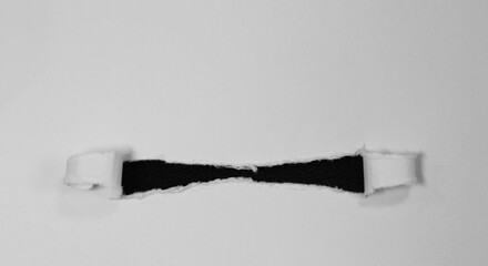 Ripped hole paper isolated on black background
