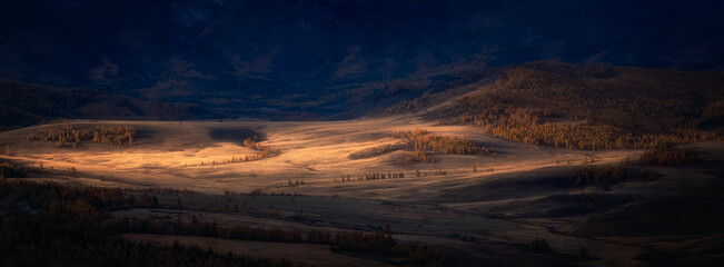 dawn ray of light in the Kurai steppe, Chui ridge, Altai Mountain in autumn, Russia