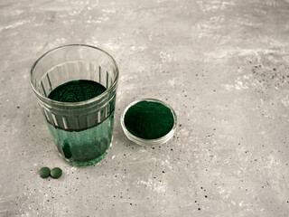 Spirulina algae in a glass of water .a superfood that contains proteins, fats, carbohydrates, and vitamins.