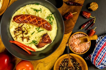 Pork sausages with mashed potato. Bangers and mash pork sausages and mashed potato. Unhealthy and greasy food. Grilled sausage.