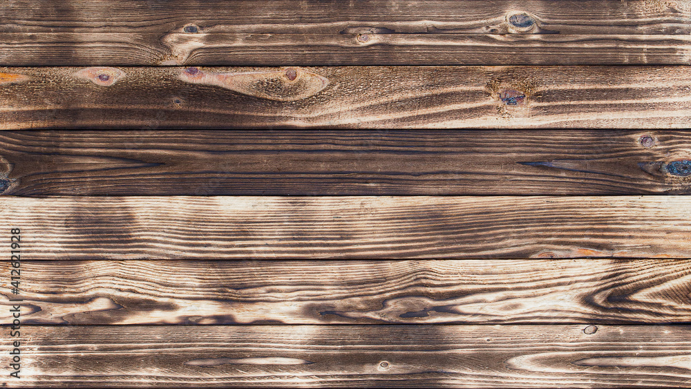 Poster wooden floor with traces of being burnt makes a black abstract background and texture.