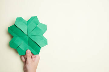 Origami green four-leaf shamrock. Concepts of luck and St. Patrick's Day