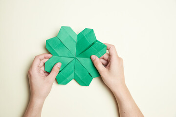 Origami green four-leaf clover. Concepts of luck and St. Patrick's Day