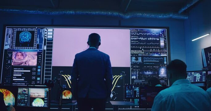 Boss walking towards screen during remote rocket launch