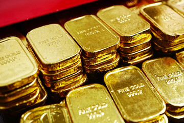 Close up stack of gold bars decorate near red envelope