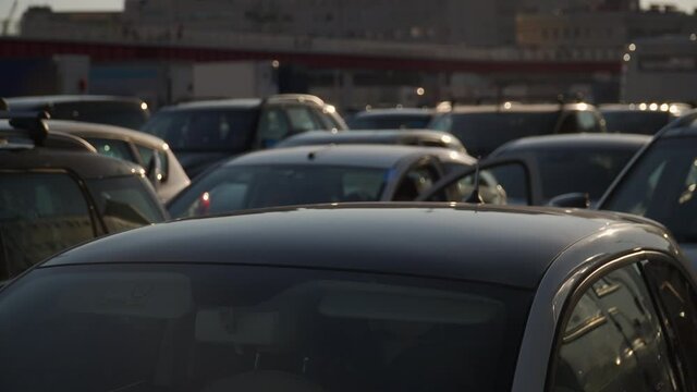 roofs of cars in a blocked line at sunset in the rush hour