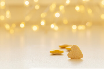 Heart shaped pill on blurred garland bokeh background