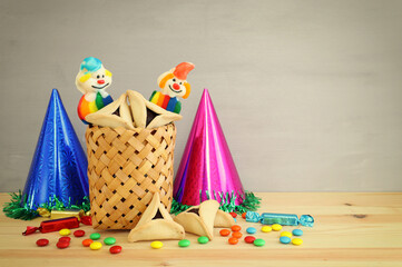 Purim celebration concept (jewish carnival holiday) over wooden table