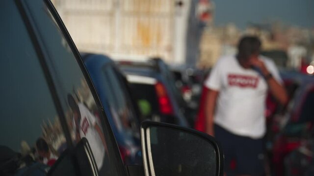a traffic lane and people outside cars waiting