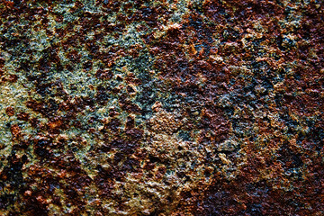 It's an old, rusty, dark-colored metal surface. Abstract background with texture on the corrosion of metals. Backdrop for the design