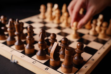 Close up of white and black chess pieces on board. Selective focus on first move of white pawn on chessboard. Concept of intelligent, logical and strategic game.