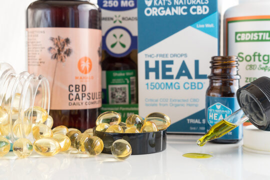 Packages of CBD products, capsules and oil tincture in an eyedropper