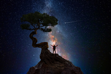 Man under a tree in front of the universe