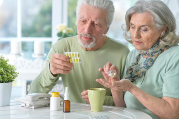 ill Senior couple with pills