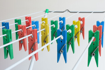 colored clothespins lined up on the clothesline