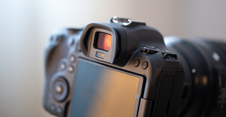 Close up part of a professional digital camera on a blurred background.