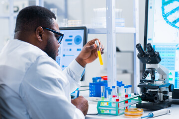 Professional African-American scientist is working on a vaccine in a modern scientific research laboratory. Genetic engineer workplace. Future technology and science.