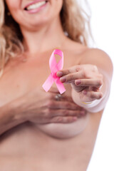 woman covering breasts with hands with pink ribbon