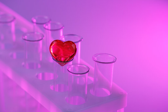 red heart on a glass test tube. Concept: love potion, synthetic love drugs, chemistry. Baby from tube vitro glass. Artificial conception 